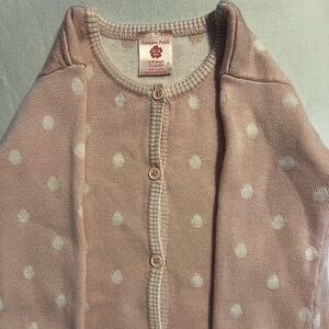 Pink sweater with white polka dots.